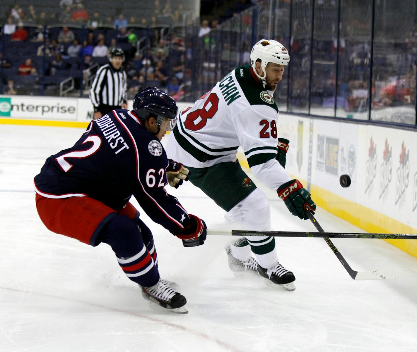 Minnesota Wild's Tyson Strachan, right, works for the puck against Columbus Blue Jackets' Alex Broadhurst during an NHL preseason hockey game in Columbus, Ohio, Thursday, Sept. 24, 2015.