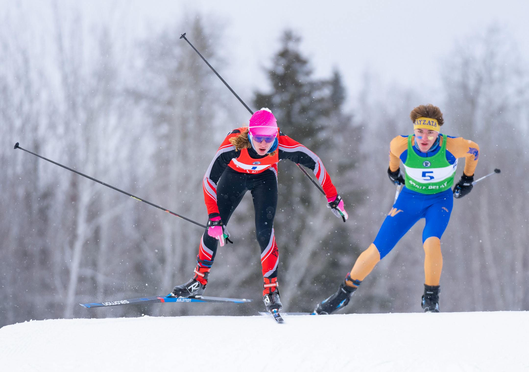 Duluth East nordic skier James Kyes (1) maintains a narrow lead over Wayzata nordic skier Ronan Leonard (5) in the second lap of the boy's team sprint final during the MSHSL Boys and Girls Nordic Ski Racing Meet.