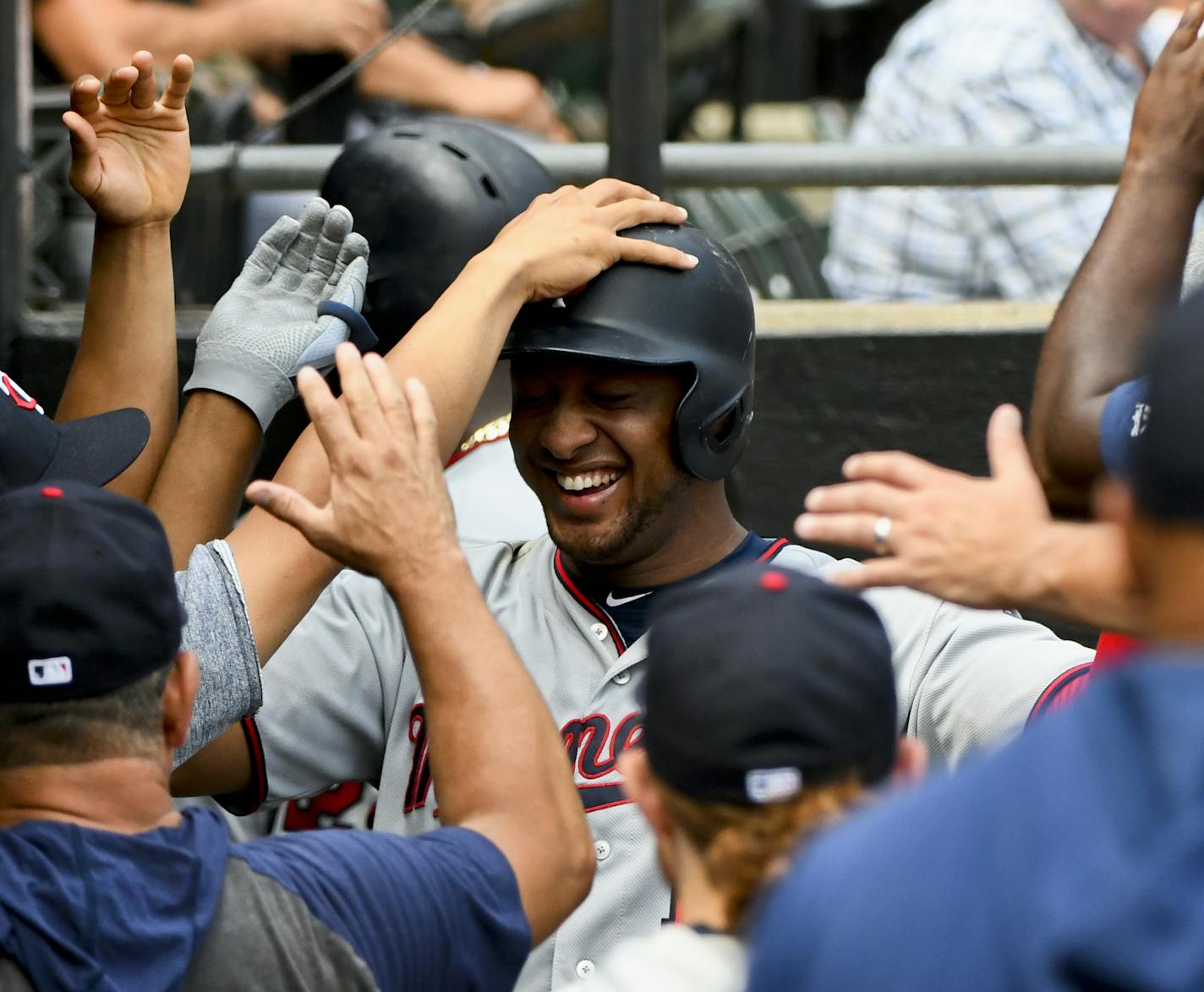 Minnesota Twins' Jonathan Schoop, center, celebrates in the dugout after his two-run home run against the Chicago White Sox during the fifth inning of a baseball game Sunday, July 28, 2019, in Chicago. (AP Photo/Matt Marton)