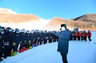Chinese President Xi Jinping speaks with athletes and coaches at the National Alpine Skiing Center in Yanqing on the outskirts of Beijing during a tou