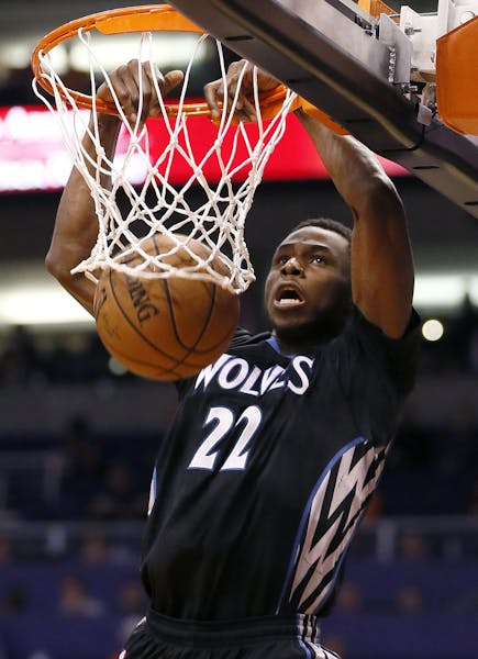 Minnesota Timberwolves' Andrew Wiggins dunks against the Phoenix Suns during the first half of an NBA basketball game, Friday, Jan. 16, 2015, in Phoen
