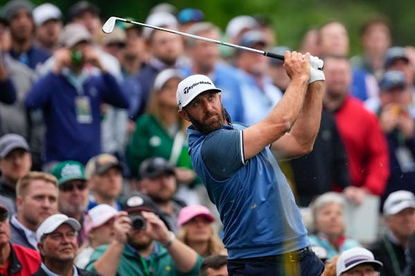 Dustin Johnson plays a practice round at Augusta National Golf Club on Monday. He is one of six Masters champions competing in this week’s tournamen