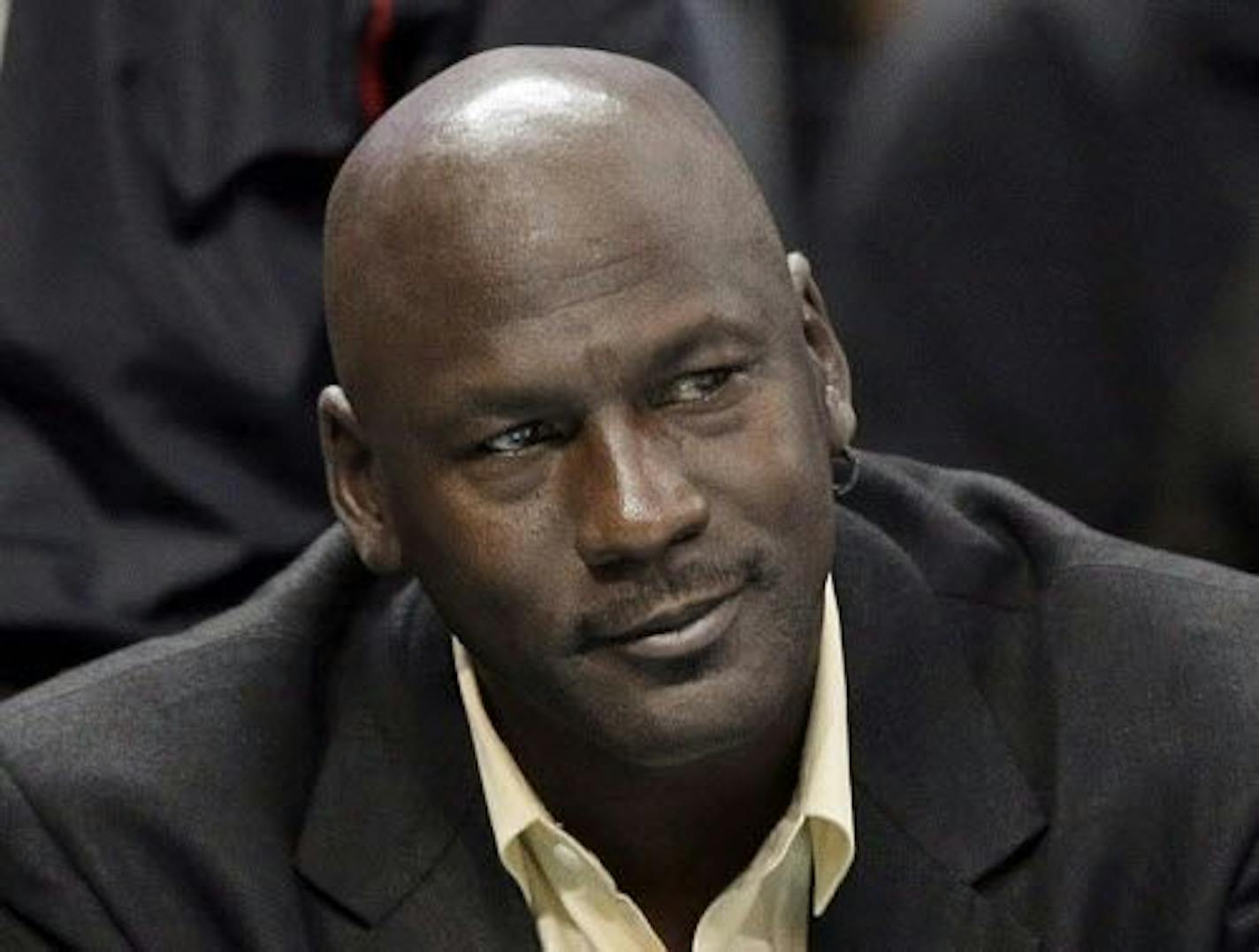 FILE - This is an April 16, 2014, file photo showing Charlotte Bobcats owner Michael Jordan watching during the first half of an NBA basketball game between the Bobcats and the Chicago Bulls in Charlotte, N.C.