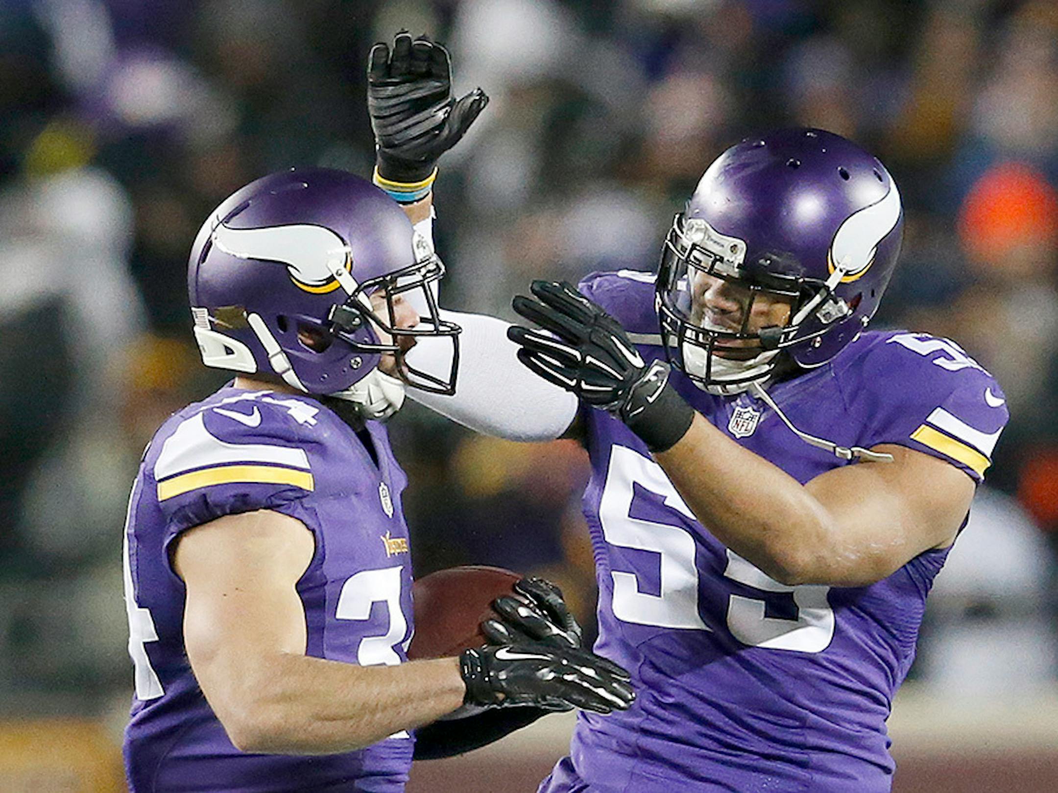 Andrew Sendejo (34) and Anthony Barr celebrated an interception by Sendejo in the first quarter.