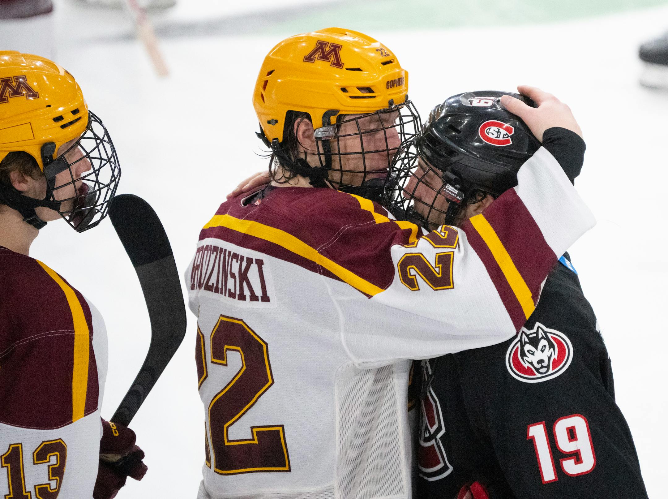 Minnesota Gophers forward Bryce Brodzinski (22) consoled his former teammate, St. Cloud State Huskies forward Grant Cruikshank (19) as the teams shook hands. The University of Minnesota Gophers defeated the St. Cloud State Huskies 4-1 in an NCAA Division I Men's Ice Hockey Championship second round game Saturday night, March 25, 2023 at Scheels Arena in Fargo, North Dakota. ] JEFF WHEELER • jeff.wheeler@startribune.com