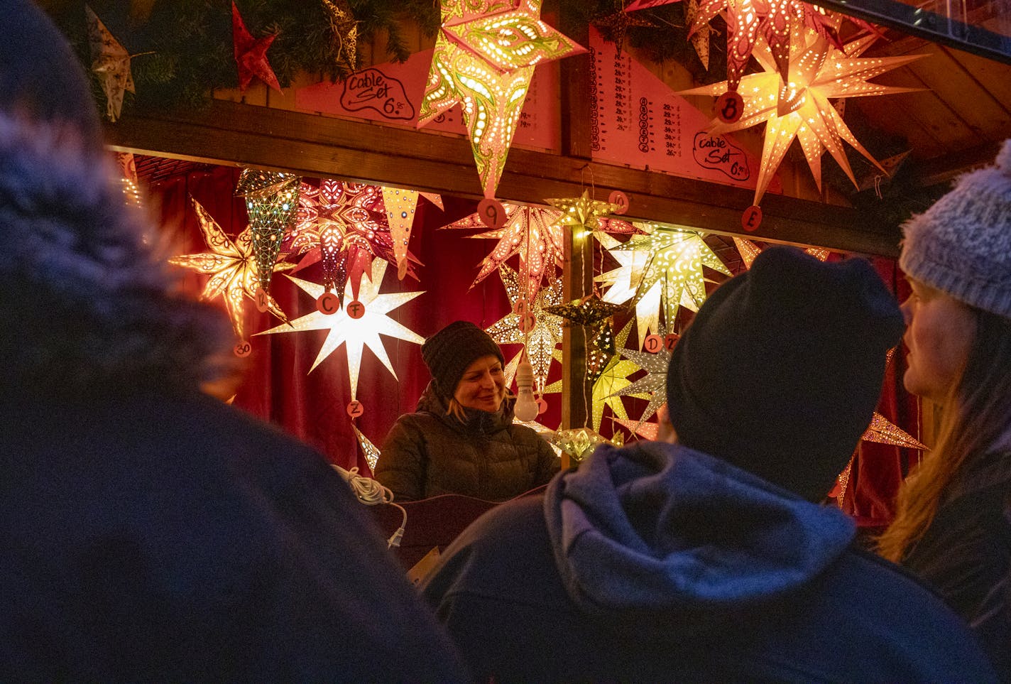 Kerzen Studio employee Jolana, who declined to give her last name, helps customers shop at Daley Center Plaza on opening day of Christkindlmarket on Nov. 15, 2019 in Chicago. (Camille Fin /Chicago Tribune/TNS) ORG XMIT: 1511865