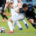 SAN JOSE, CALIFORNIA - MARCH 9: Minnesota United's Rasmus Schuller (20) and San Jose Earthquakes' Nick Lima (24) battle for the ball during the first 