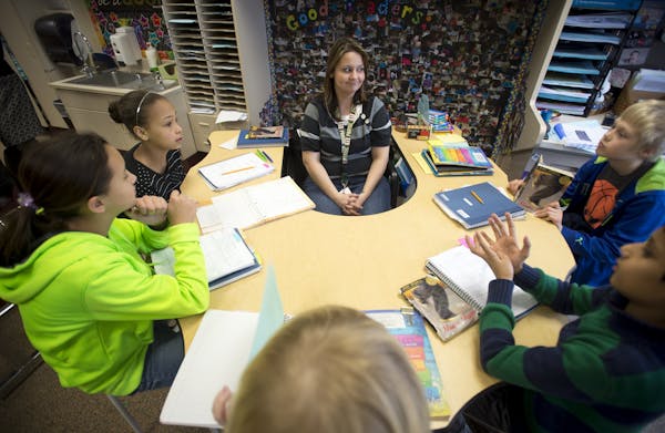 Glacier Hills Elementary fourth grade teacher Ms. Houlding meets with a small group of students in her class on Tuesday afternoon. ] (Aaron Lavinsky |