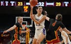 Goodhue guard Elisabeth Gadient (25) passes over Mountain Iron-Buhl guard Jordan Zubich during Saturday's Class 1A title game at Williams Arena.