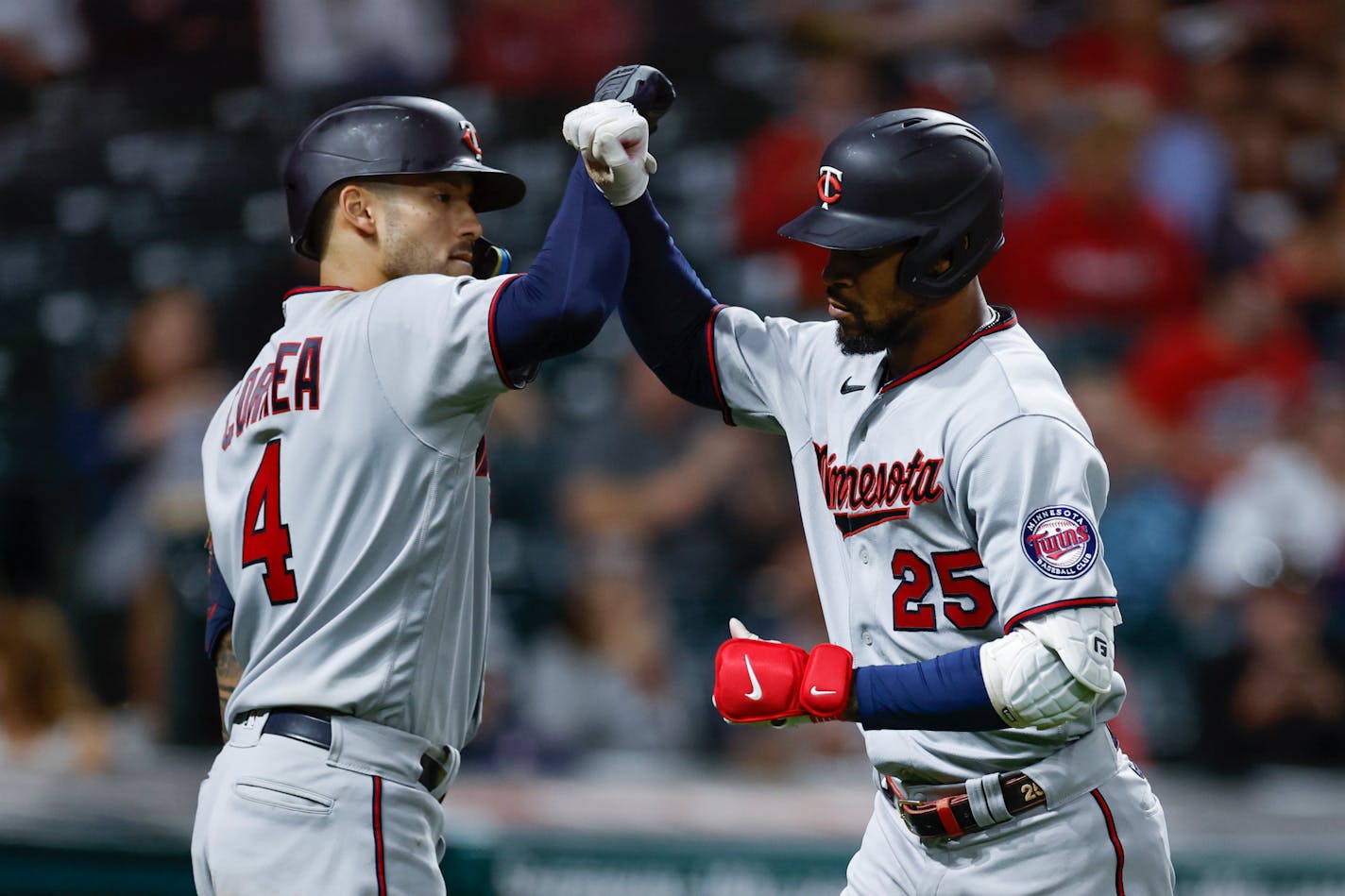 Minnesota Twins' Byron Buxton (25) celebrates with Carlos Correa (4) after hitting a solo home run against the Cleveland Guardians during the ninth inning in the second baseball game of a doubleheader, Tuesday, June 28, 2022, in Cleveland. (AP Photo/Ron Schwane)