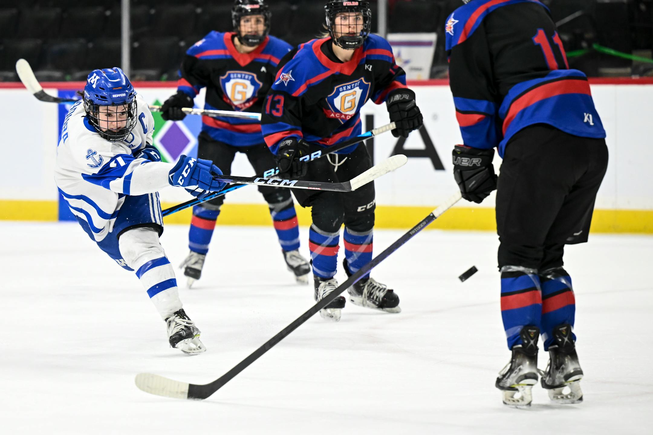 Minnetonka forward Grace Sadura (7) attempts a shot as she's pursued by Gentry defenders during the first period.