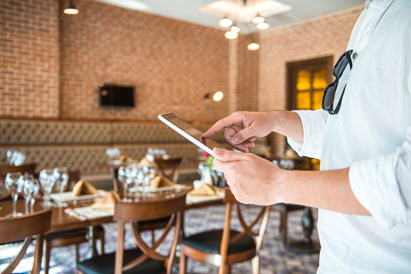 Man using tablet in restaurant