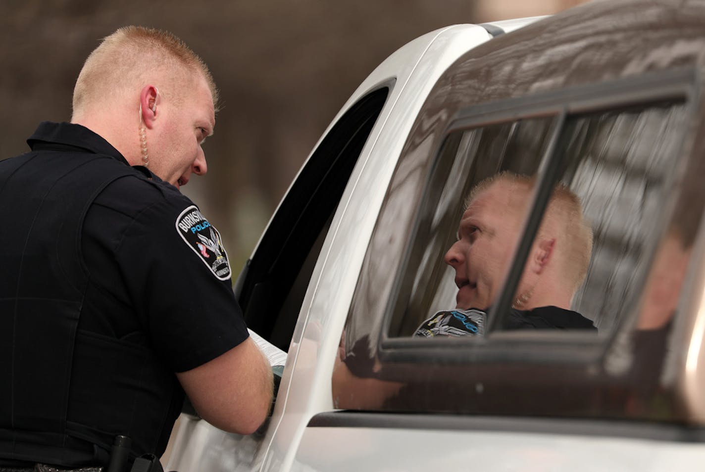 Officer Chris Walswick with the Burnsville Police Department talked with a driver during a traffic stop Wednesday. ] ANTHONY SOUFFLE &#x2022; anthony.souffle@startribune.com Officer Chris Walswick with the Burnsville Police Department patrolled looking for texting and distracted drivers as part of the Dakota County traffic detail Wednesday, April 12, 2017 in Apple Valley, Minn.