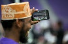 Muslim worshiper photographs the impressive setting Tuesday, Aug. 21, 2018, at U.S. Bank Stadium in Minneapolis, Minn. To celebrate Eid ul-Adha, the o