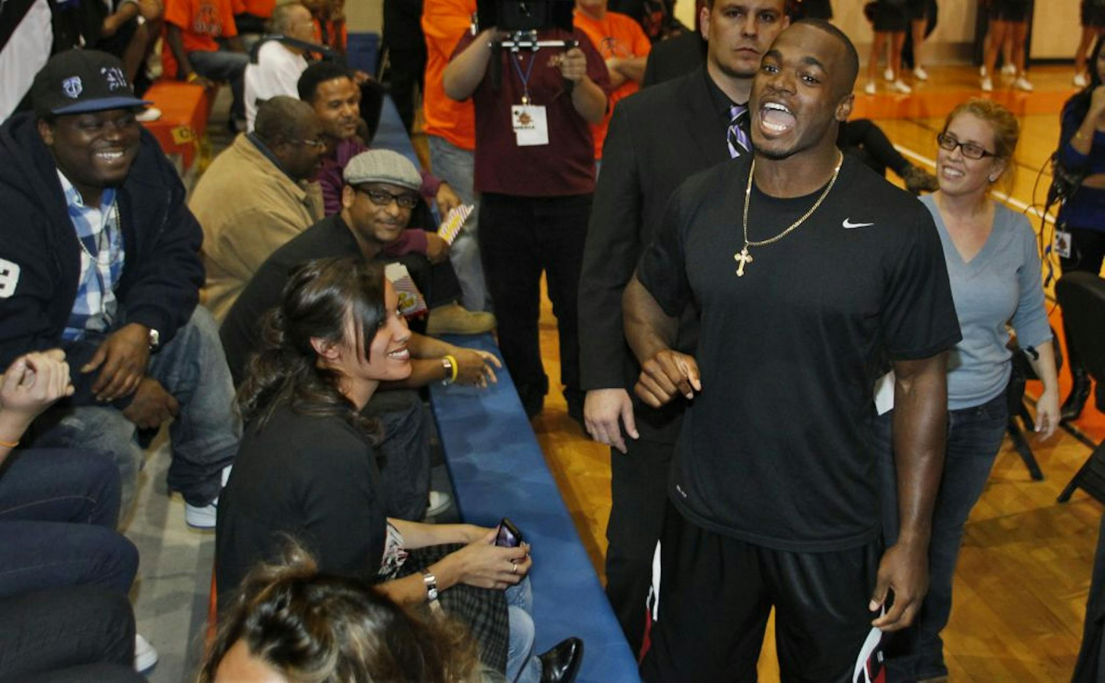 Michael Beasley's all-star basketball game with NBA players at Osseo High School. Viking running back Adrian Peterson shouted out greetings to fans in attendance. Peterson served as a coach to one of the participating teams.