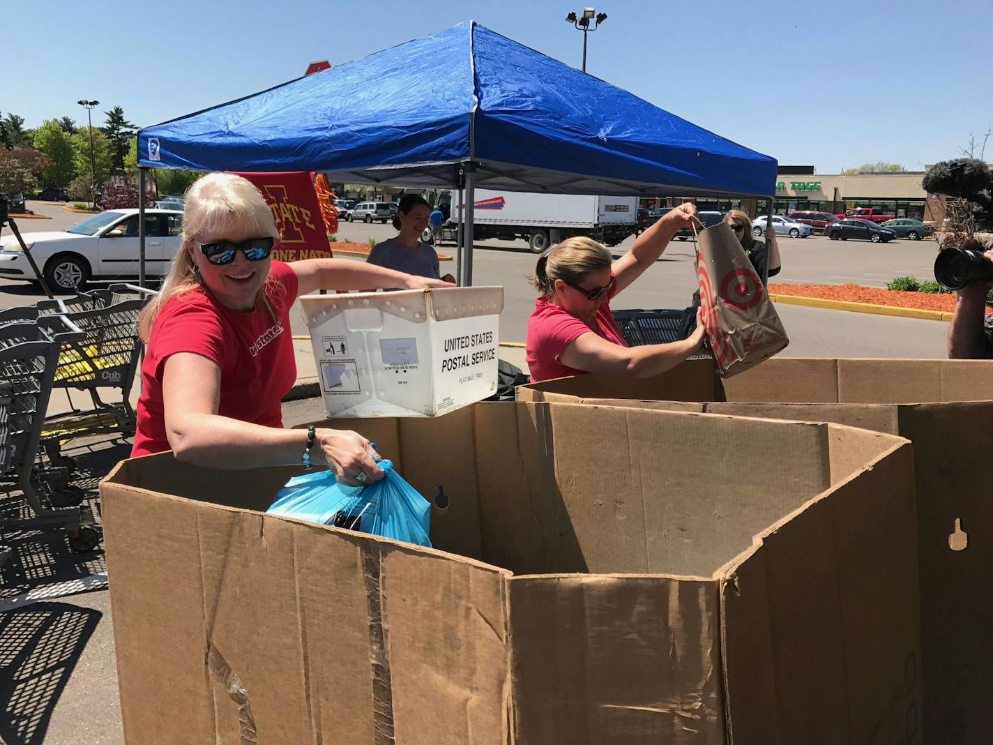 Terri Krysan, of Lakeville, and Sonya Smith, of Orlinda, Tenn., place donations into larger boxes during the Stamp Out Hunger event in Bloomington on Saturday, May 13.