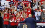 Supporters cheer as President Donald Trump acknowledges them during a campaign rally Thursday, Oct. 10, 2019, in Minneapolis. (AP Photo/Jim Mone)