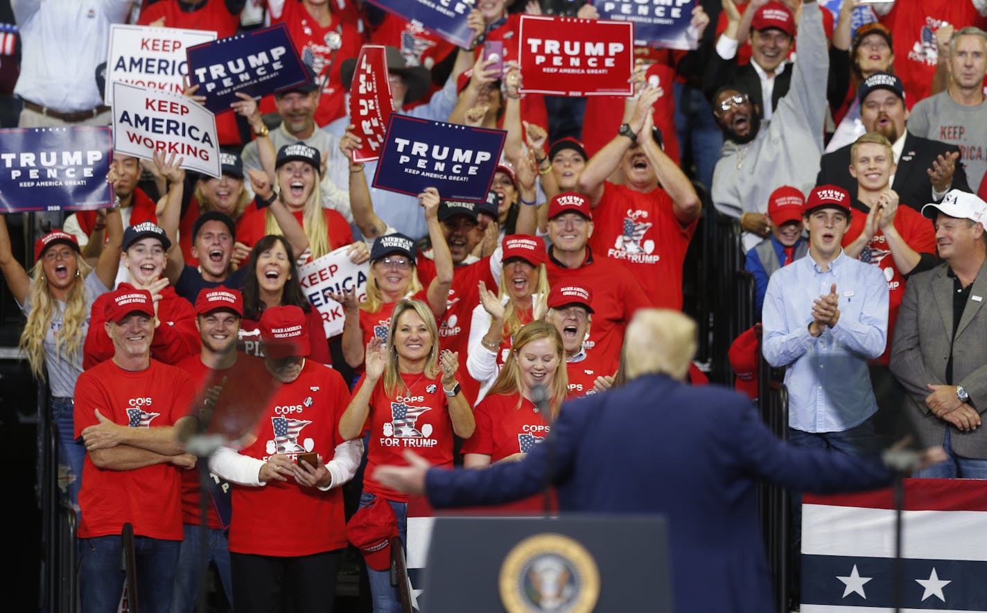 Supporters cheer as President Donald Trump acknowledges them during a campaign rally Thursday, Oct. 10, 2019, in Minneapolis. (AP Photo/Jim Mone)