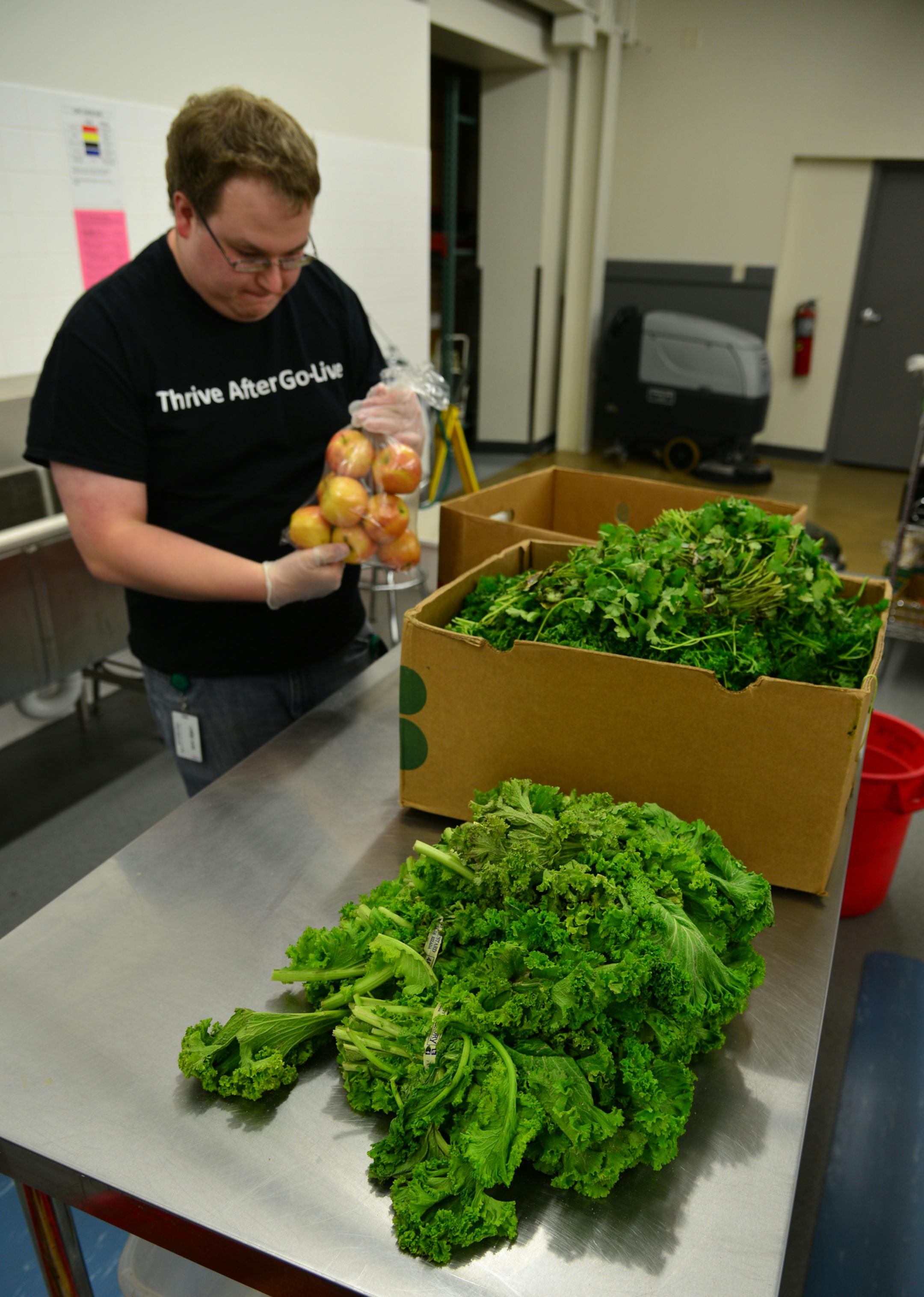 Danny Nutting of Bloomington volunteers once a week in the food shelf area of VEAP. For the first time, the nonprofit has its own kitchen space.