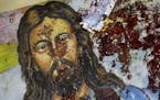 A blood-spattered poster of Jesus Christ is seen inside the the Coptic Christian Saints Church in the Mediterranean port city of Alexandria, Egypt Sat
