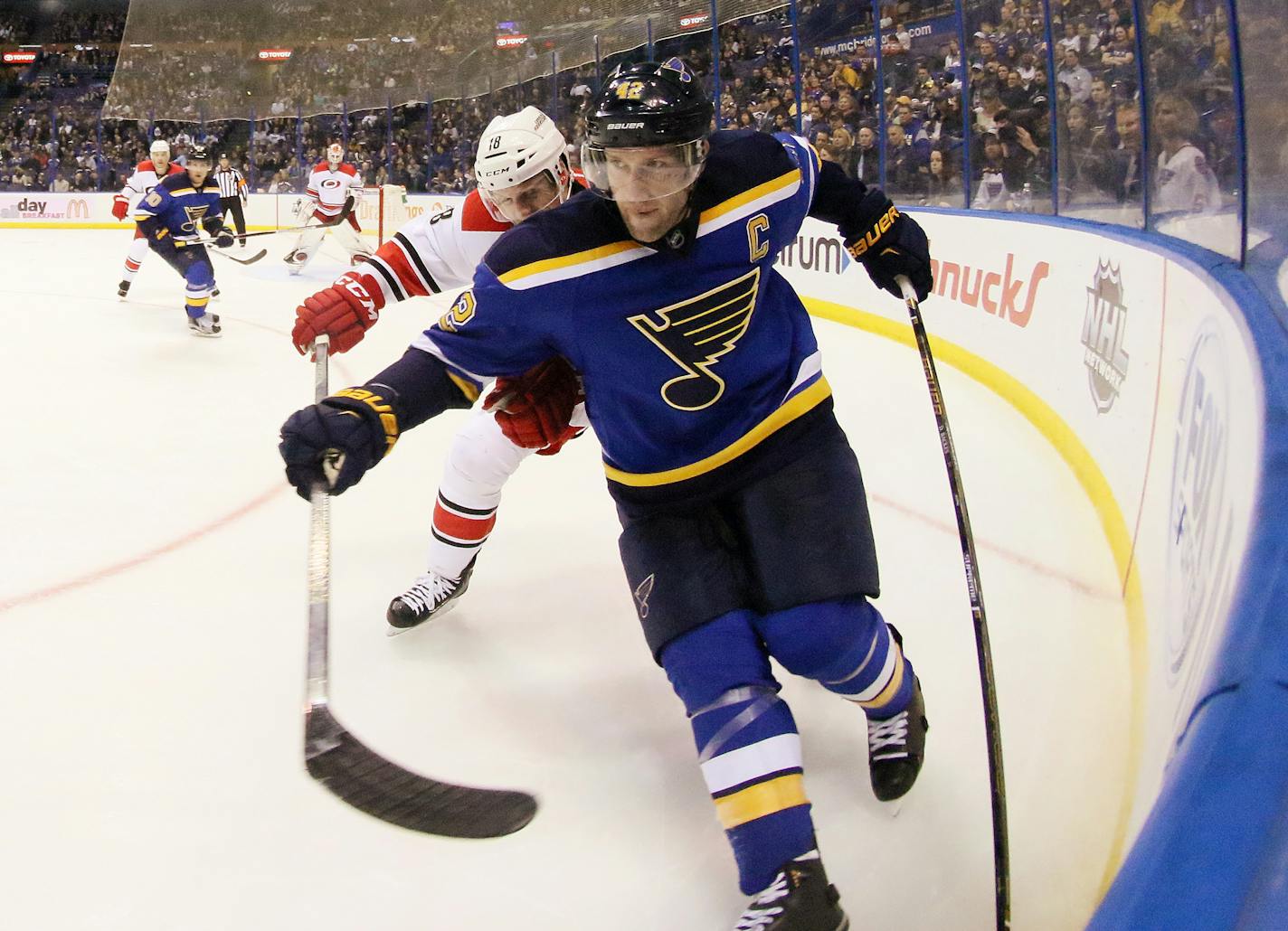 St. Louis Blues center David Backes holds off the stick of Carolina Hurricanes center Jay McClement in the third period of an NHL hockey game Thursday, Jan. 14, 2016, in St. Louis. (Chris Lee/St. Louis Post-Dispatch via AP) EDWARDSVILLE INTELLIGENCER OUT; THE ALTON TELEGRAPH OUT; MANDATORY CREDIT