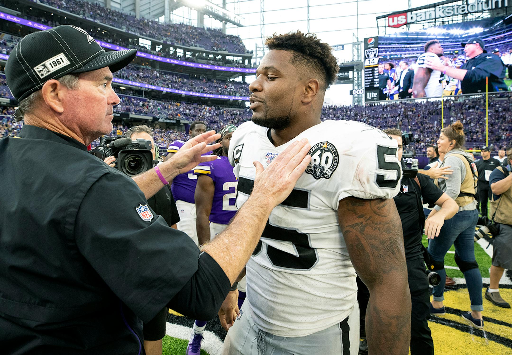 Minnesota Vikings head coach Mike Zimmer greeted Oakland Raiders' Vontaze Burfict at the end of the game.