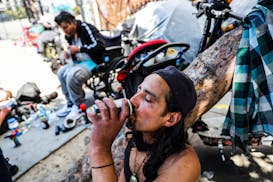 A homeless man named Angel drinks a soda to keep cool during a heat wave in San Francisco on Wednesday, July 3, 2024.