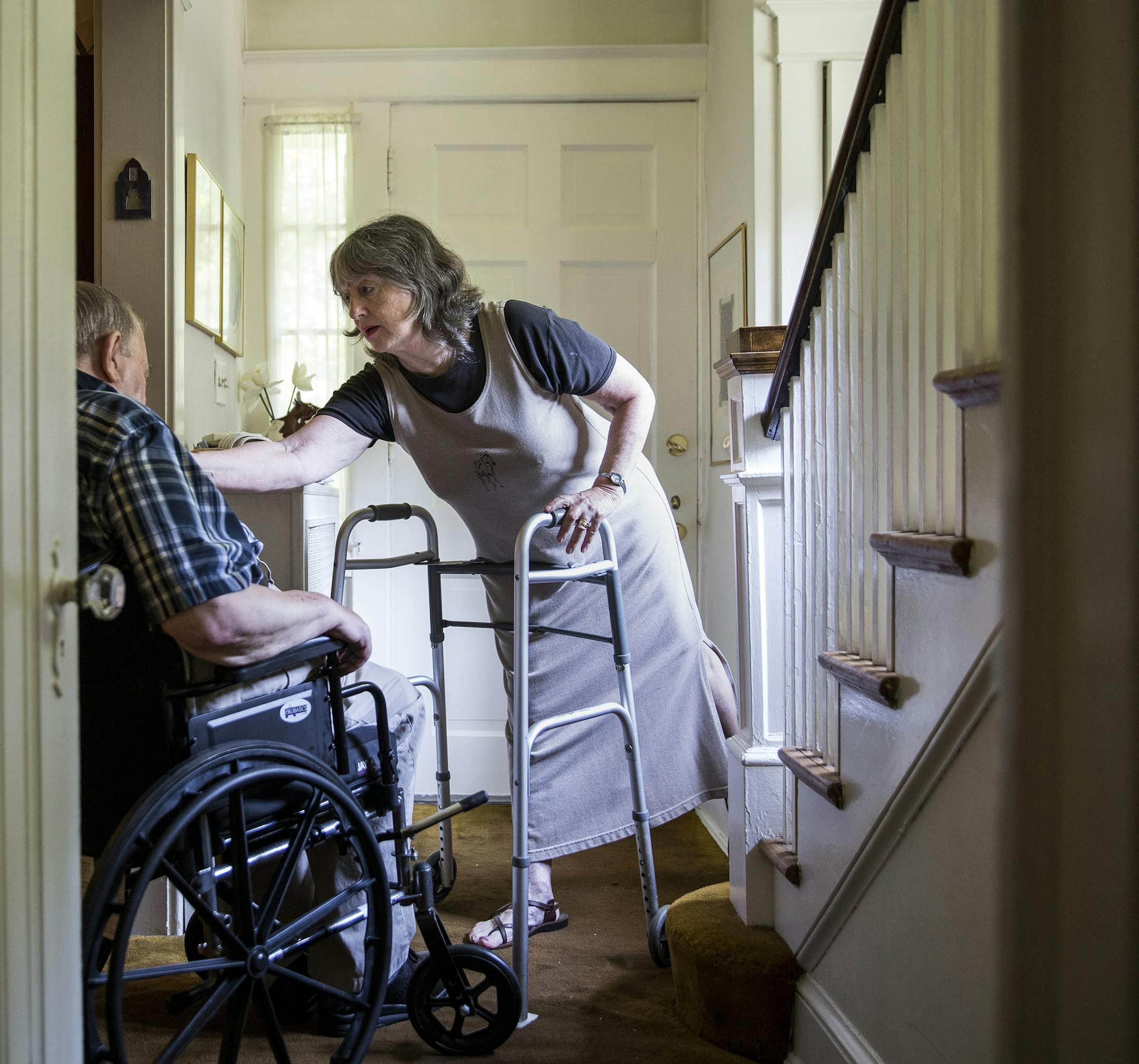 Gail Schwartz, 78, helps her husband David, 85, out of his wheelchair at their home in Chevy Chase, Md., July 1, 2015. A rising reality for many elder Americans with health problems: they are cared for by partners, siblings, friends and even parents who are also elderly. (Drew Angerer/The New York Times) ORG XMIT: XNYT23