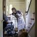 Gail Schwartz, 78, helps her husband David, 85, out of his wheelchair at their home in Chevy Chase, Md., July 1, 2015. A rising reality for many elder