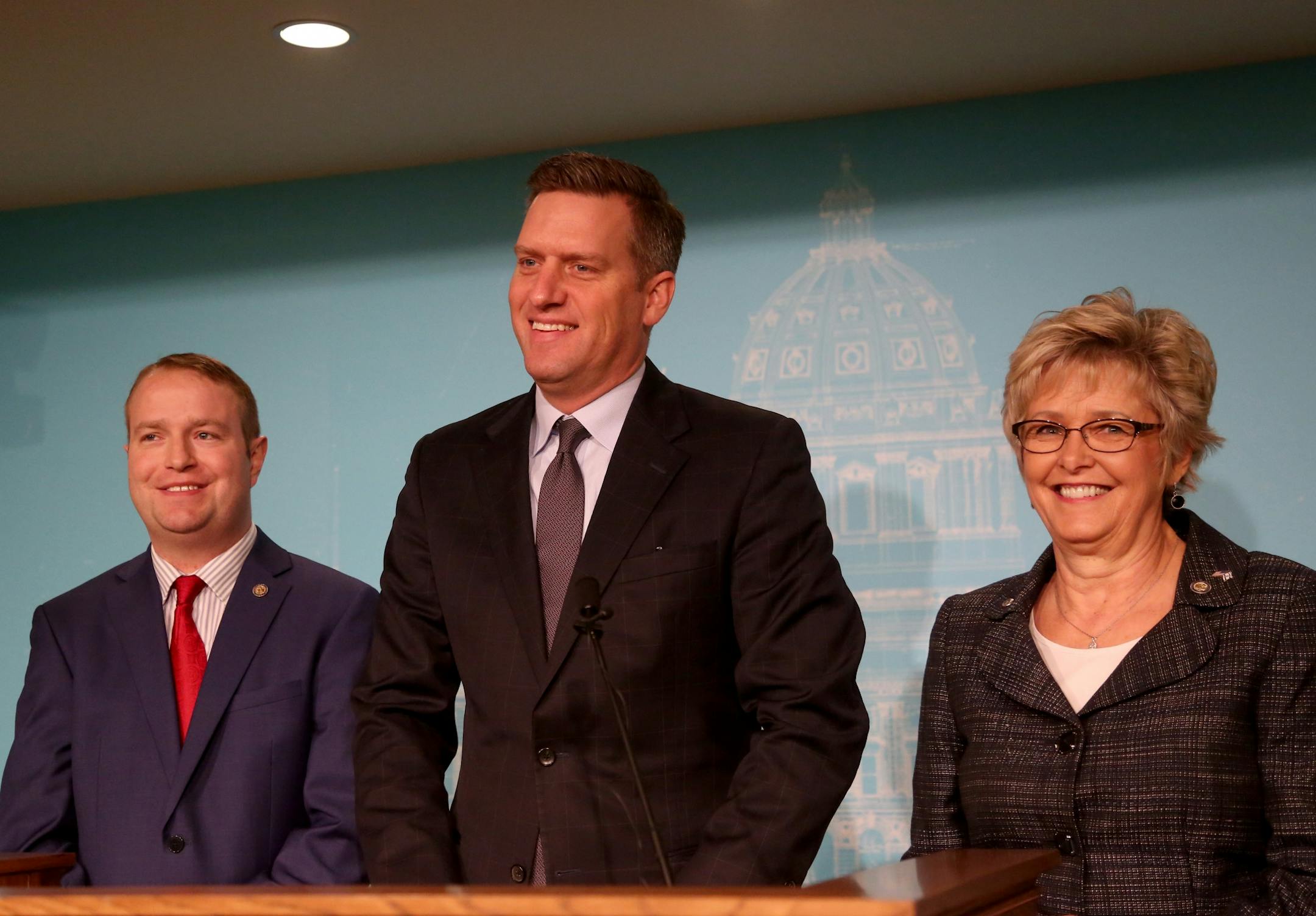 Minnesota House Speaker Kurt Daudt, center, appeared with fellow Republican legislators Rep. Nick Zerwas (R-Elk River), left, and Rep. Kathy Lohmer (R-Stillwater), right, during a press conference in which Lohmer and Zerwas, the authors of two house bills that would add to penalties imposed on protestors who block highways, roads and transit, talked about their bills Wednesday, Feb. 2017, at the State Capitol in St. Paul, MN. The press conference opened with a light moment after a reporter comme