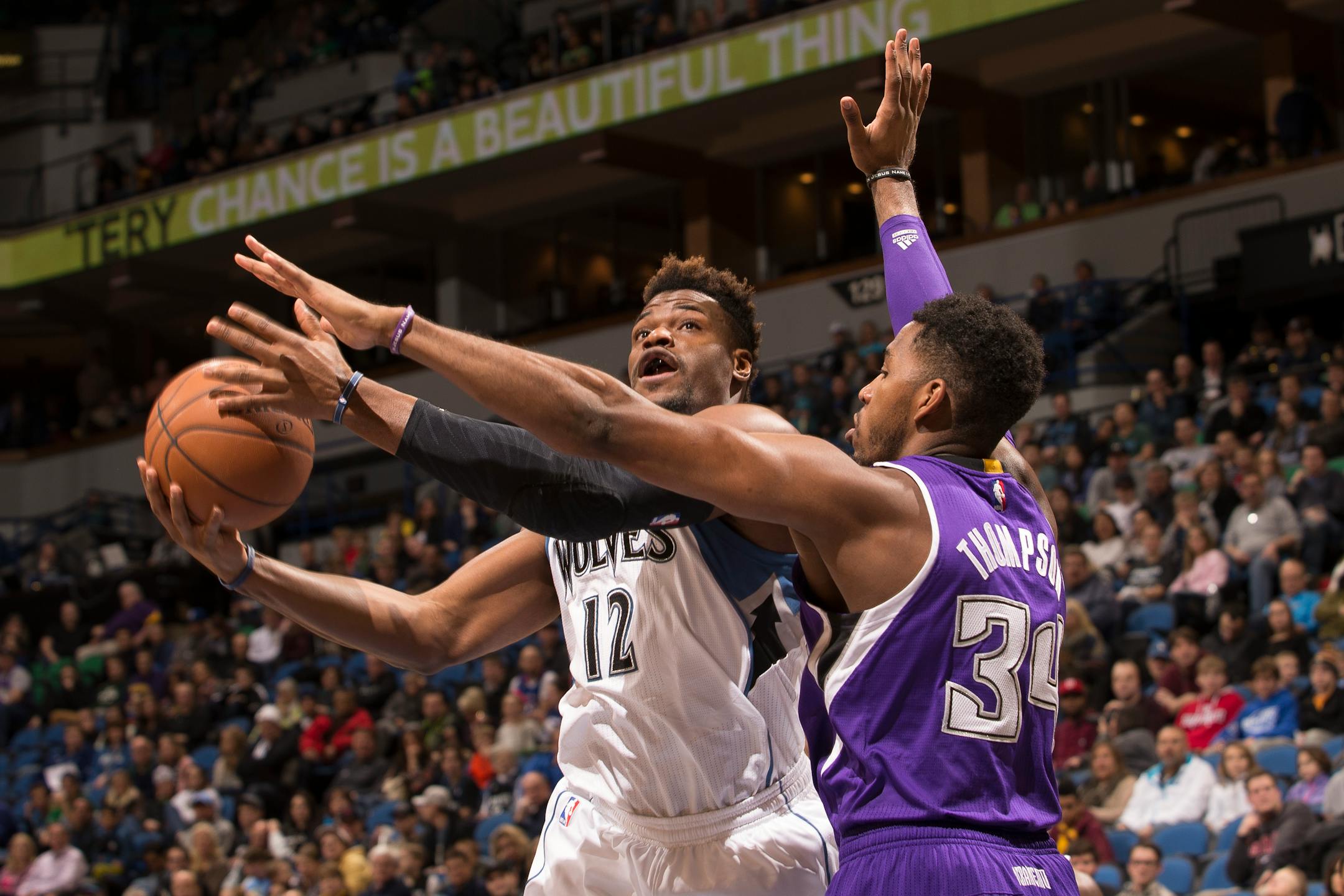 Minnesota Timberwolves forward Jeff Adrien (12) charges toward the basket while being defended by Sacramento Kings forward Jason Thompson (34) during the first half.