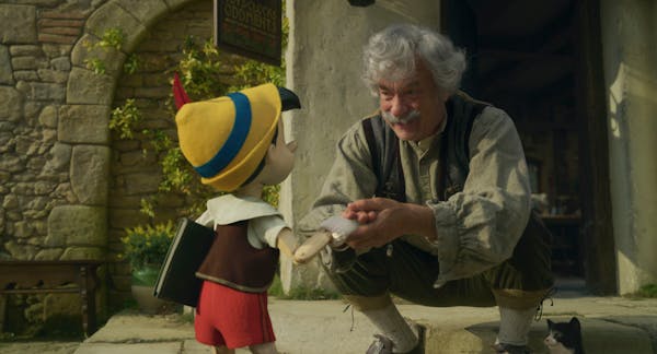 (L-R): Pinocchio (voiced by Benjamin Evan Ainsworth), Tom Hanks as Geppetto, and Figaro in Disney's live-action PINOCCHIO, exclusively on Disney+. Pho
