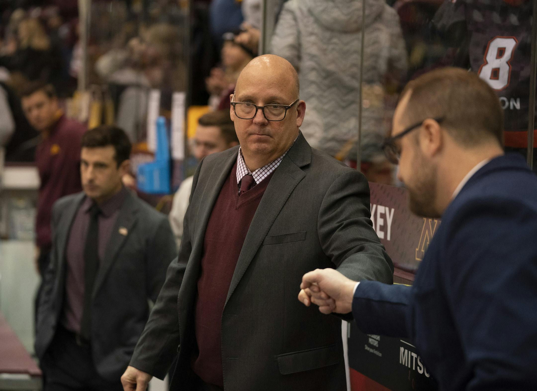 University of Minnesota men's hockey head coach Bob Motzko fist bumped an assistant after the 4-1 win over St. Cloud State, his former team. ] JEFF WHEELER • Jeff.Wheeler@startribune.com The University of Minnesota men's hockey team defeated St. Cloud State 4-1 in the championship game of the Mariucci Classic tournament Sunday night, December 29, 2019 at 3M Arena at Mariucci in Minneapolis.