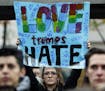 A protester holds a sign that reads "Love Trumps Hate" during a protest against the election of President-elect Donald Trump, Wednesday, Nov. 9, 2016 