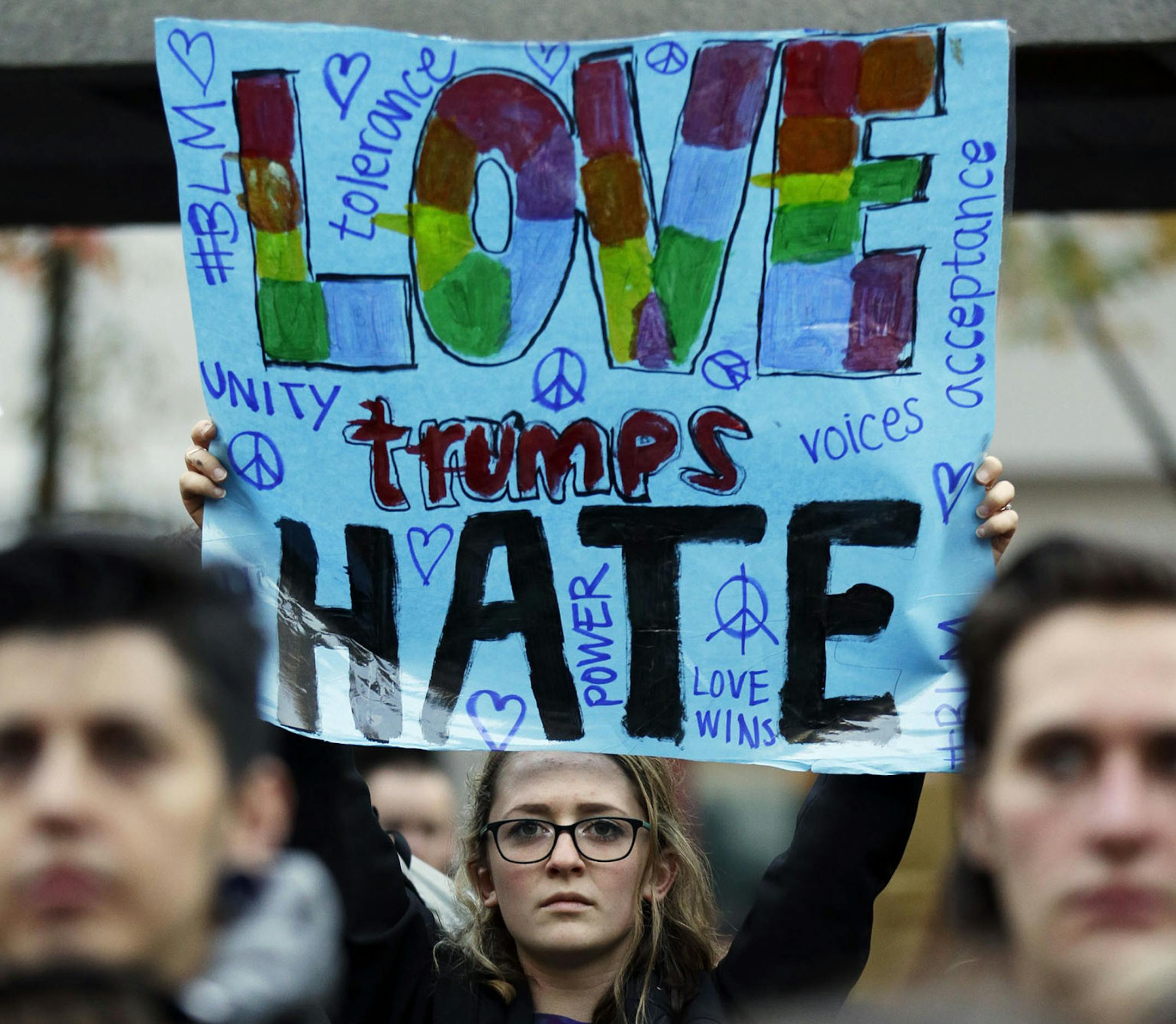 A protester holds a sign that reads "Love Trumps Hate" during a protest against the election of President-elect Donald Trump, Wednesday, Nov. 9, 2016 in downtown Seattle. A day after Trumpís election as president, the divisions he exposed only showed signs of widening as many thousands of protesters flooded streets across the country to condemn him. (AP Photo/Ted S. Warren) ORG XMIT: MIN2016111017061488