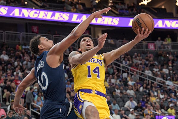 Minnesota Timberwolves guard Bryn Forbes (10) defends against Los Angeles Lakers guard Scotty Pippen Jr. (14) during the first half of an NBA preseaso