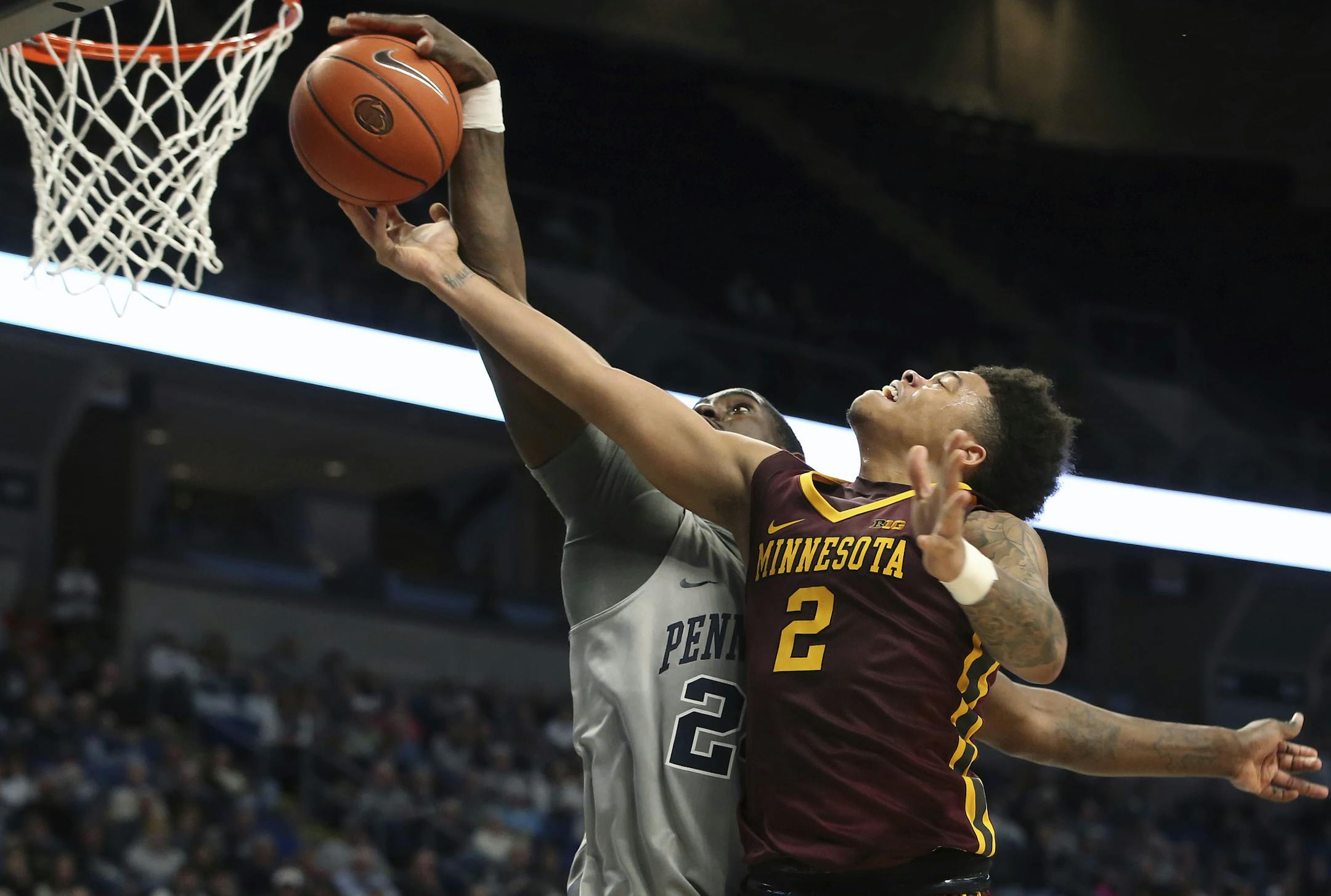 Penn State's Mike Watkins (24) blocks a shot by Minnesota's Nate Mason (2) during the second half of an NCAA college basketball game in State College, Pa., Saturday, Jan. 14, 2017. Penn State won the game 52-50. (AP Photo/Chris Knight)