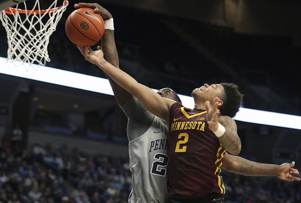 Penn State's Mike Watkins (24) blocks a shot by Minnesota's Nate Mason (2) during the second half of an NCAA college basketball game in State College,