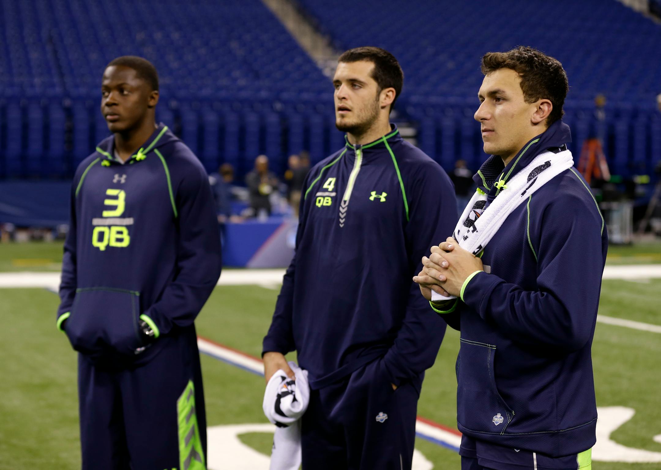 Texas A&M quarterback Johnny Manziel, right, Fresno State quarterback Derek Carr, center, and Louisville quarterback Teddy Bridgewater watch drills at the NFL football scouting combine in 2014. They were all taken in the NFL draft's first 36 picks.