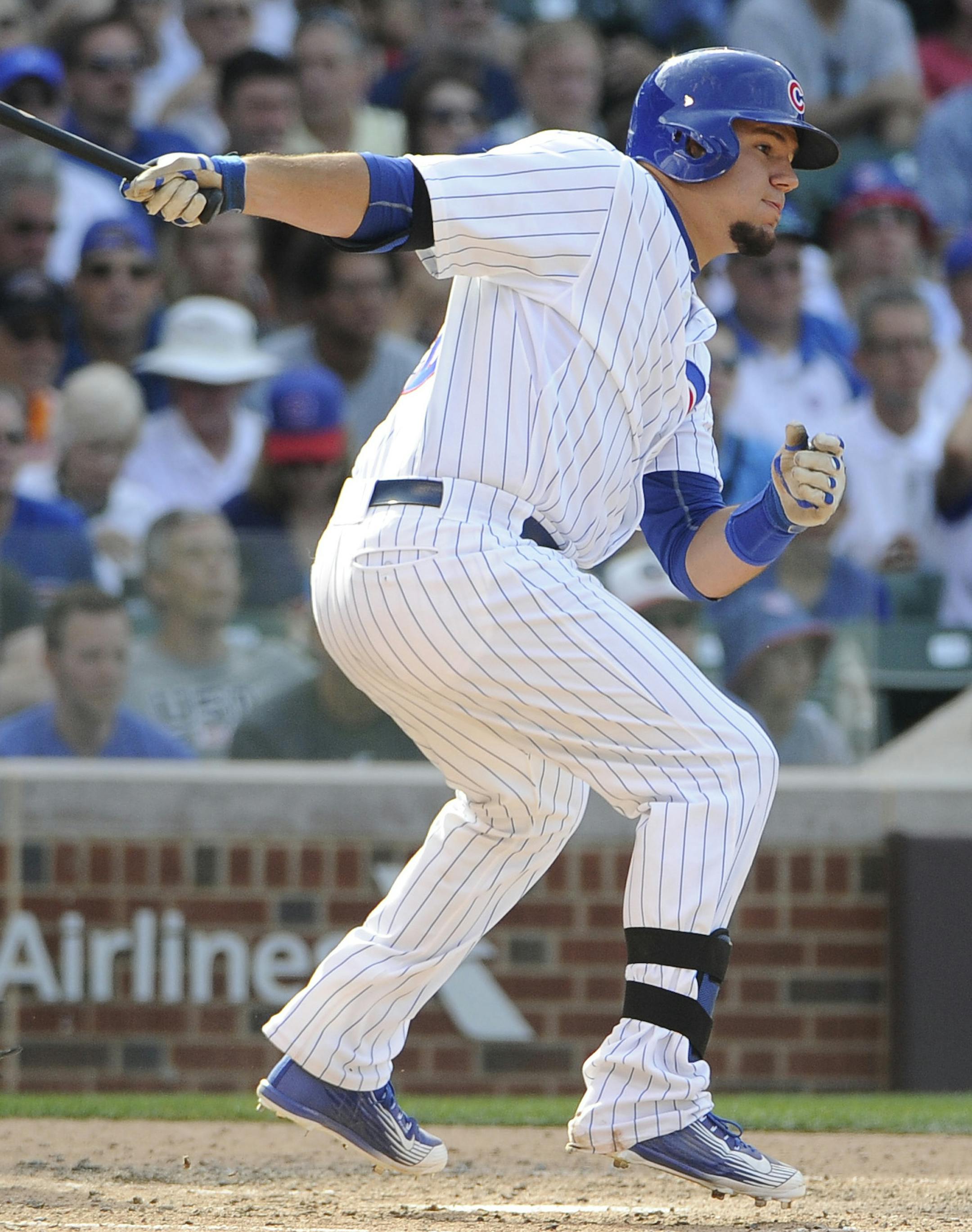 Chicago Cubs' Kyle Schwarber, right, hits a two-RBI single against the San Francisco Giants during the fifth inning of a baseball game, Friday, Aug. 7, 2015, in Chicago. (AP Photo/David Banks)