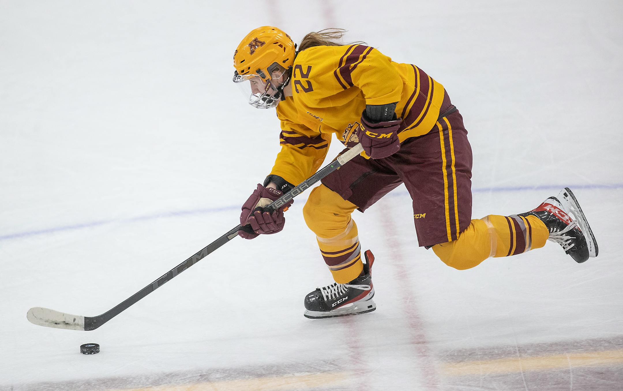 Minnesota forward Abigail Boreen (22) skates with puck during the first period at Ridder Arena, in Minneapolis, Minn., on Saturday, March 12, 2022. The Gophers women's hockey playing the Minnesota Duluth Bulldogs for a berth in Women's Frozen Four. ] Elizabeth Flores • liz.flores@startribune.com
