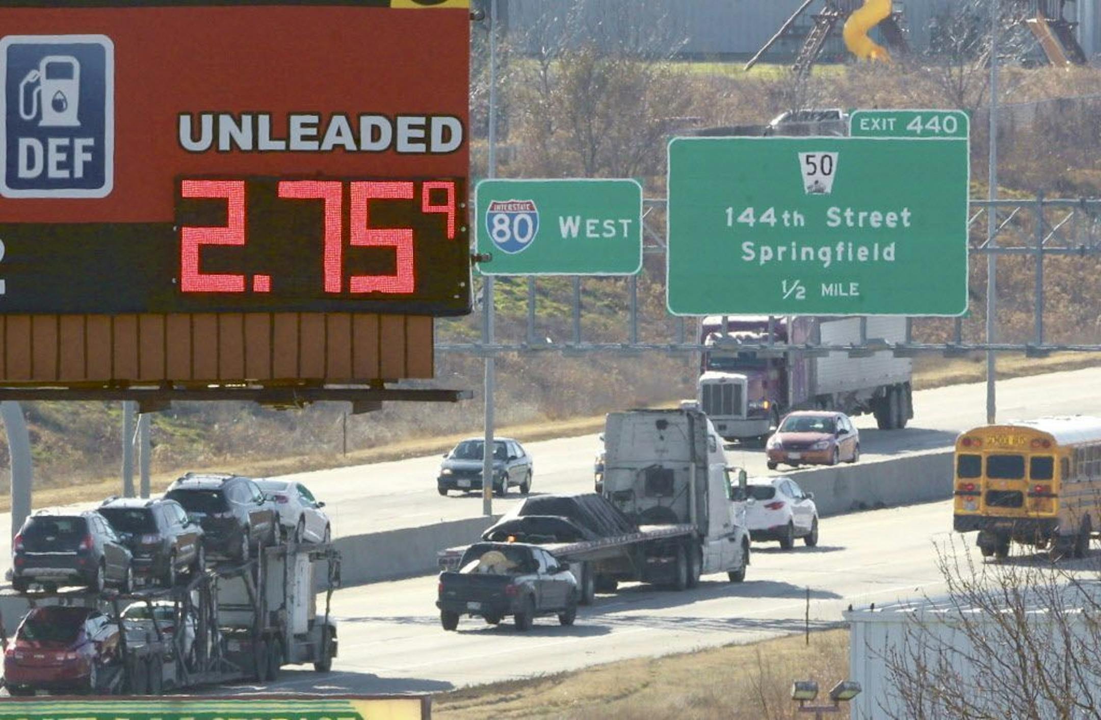 In this photo taken on Tuesday, Nov. 25, 2014, a sign advertising the price of gas towers over Interstate 80 in Omaha, Neb. The cheapest gas in half a decade is expected to entice more Americans to pile into cars, trucks and vans for their Thanksgiving journeys.