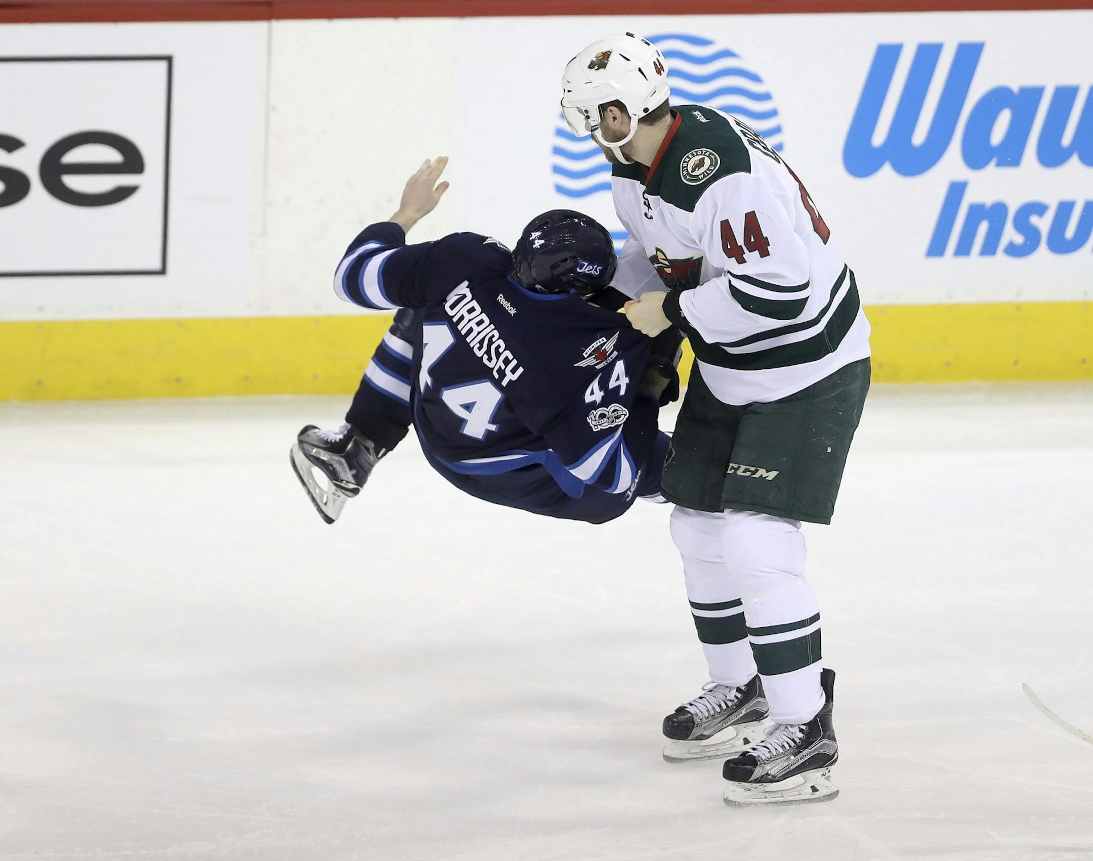 Minnesota Wild's Tyler Graovac (44) holds Winnipeg Jets' Josh Morrissey (44) by the jersey after Morrissey collided with Charlie Coyle during the third period of an NHL hockey game Tuesday, Feb. 28, 2017, in Winnipeg, Manitoba.