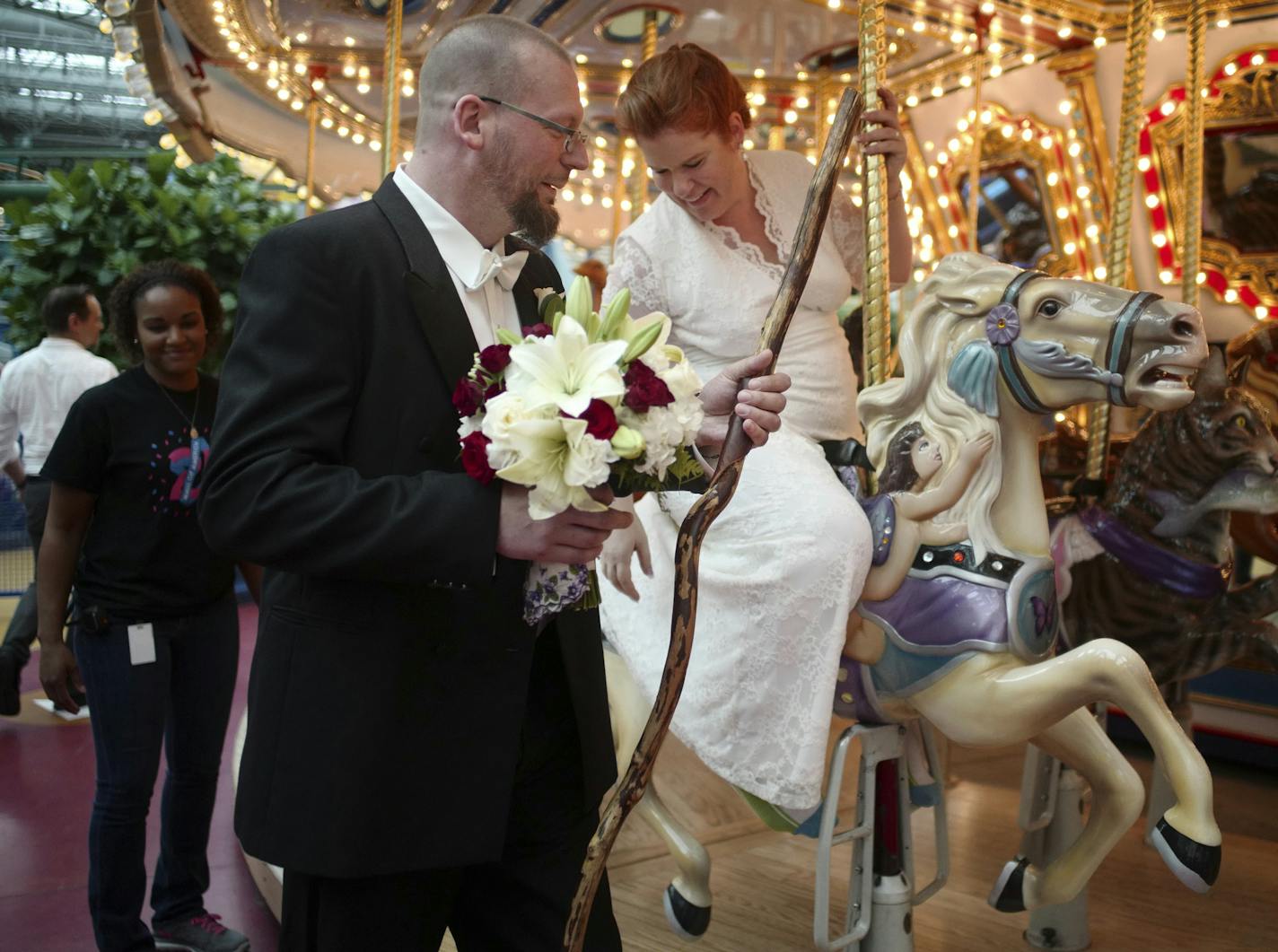 FILE - In this Aug. 18, 2017, file photo, David and Elizabeth Weinlick pose for a photograph after renewing their wedding vows at the Mall of America in Bloomington, Minn. The groom who said "I do" to a woman he had just met in a well-publicized wedding at the Mall of America nearly 20 years ago has died of colon cancer. David Weinlick was 48. Minneapolis City Council member Steve Fletcher, a friend who helped arrange Weinlick's marriage to Elizabeth Runze in June 1998, says Weinlick died Sunday