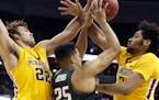 Minnesota center Reggie Lynch (22) and forward Jordan Murphy, right, combine to defend Michigan State forward Kenny Goins (25) during the second half 