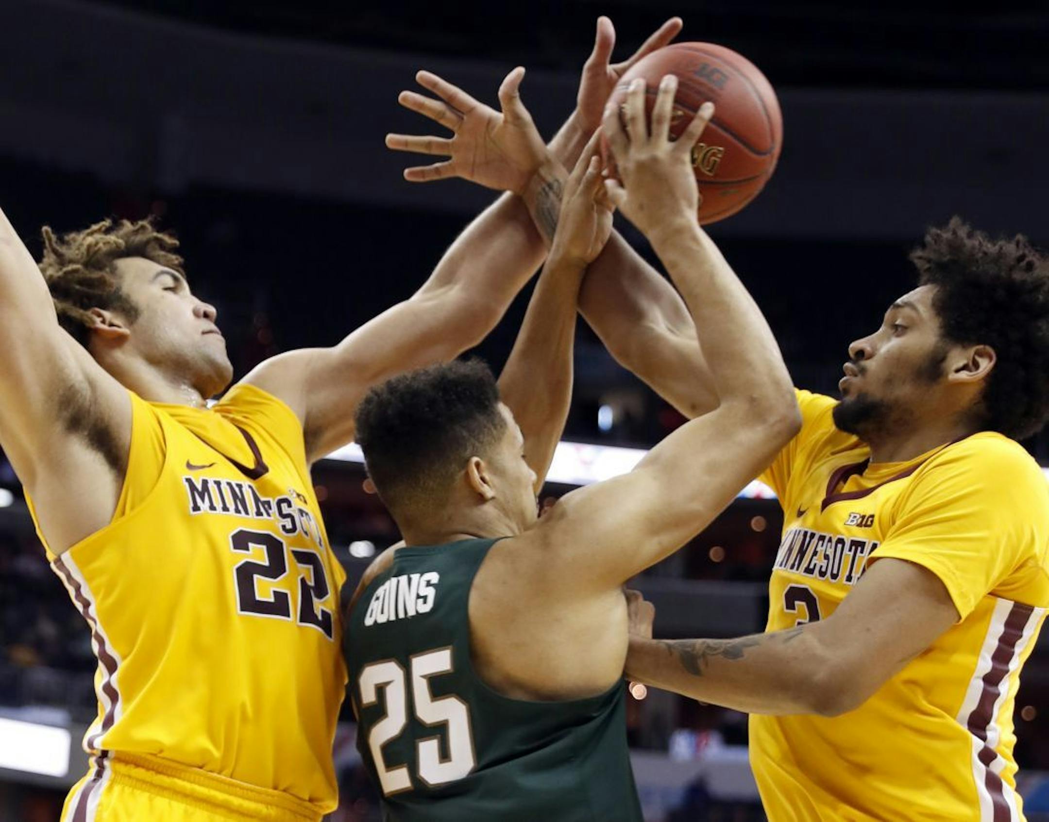 Minnesota center Reggie Lynch (22) and forward Jordan Murphy, right, combine to defend Michigan State forward Kenny Goins (25) during the second half of an NCAA college basketball game in the Big Ten tournament, Friday, March 10, 2017, in Washington.