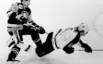 November 10, 1991 The Stars' Mike Modano was sent flying as he tried to steal the puck from the Penguins's Bryan Trottier. November 9, 1991 Marlin Lev