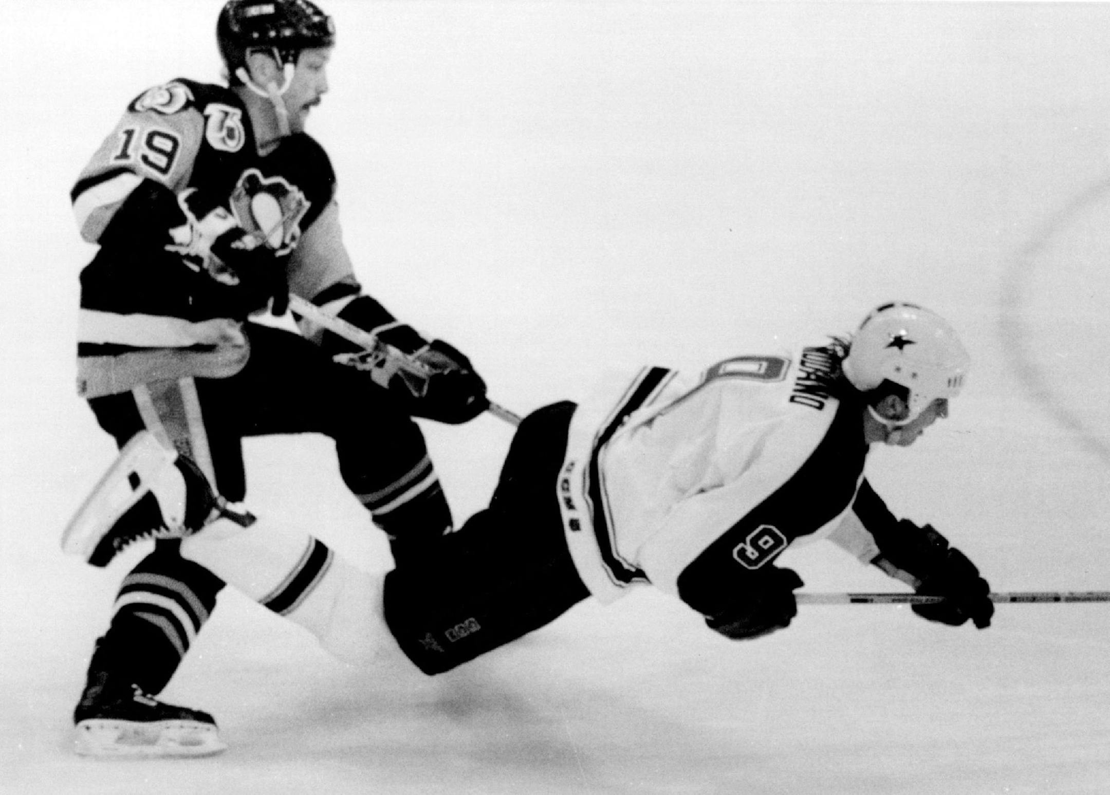 November 10, 1991 The Stars' Mike Modano was sent flying as he tried to steal the puck from the Penguins's Bryan Trottier. November 9, 1991 Marlin Levison, Minneapolis Star Tribune
