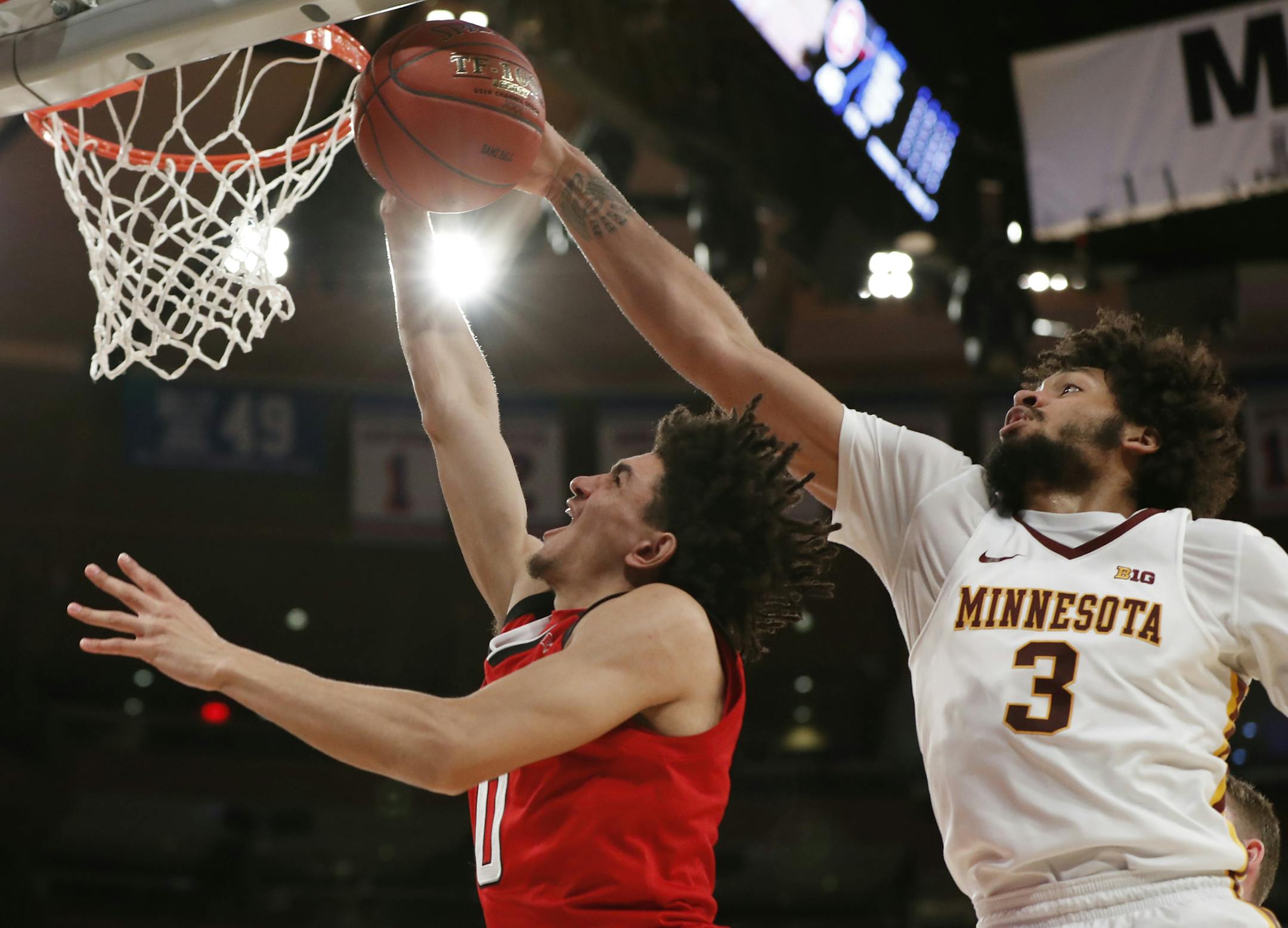 Minnesota forward Jordan Murphy (3) defends as Rutgers guard Geo Baker (0) shoots during the second half of an NCAA college basketball game in the first round of the Big Ten men's tournament Wednesday, Feb. 28, 2018, in New York. Rutgers defeated Minnesota 65-54. (AP Photo/Kathy Willens)