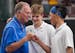 Blake head coach Ted Warner, left, congratulates Andrew Richardson, center, and Kai Chen after winning the state Class 2A doubles championship against